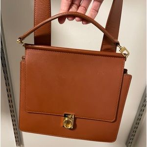 Polene Numero Sept (#7) leather crossbody body in cognac with gold hardware.